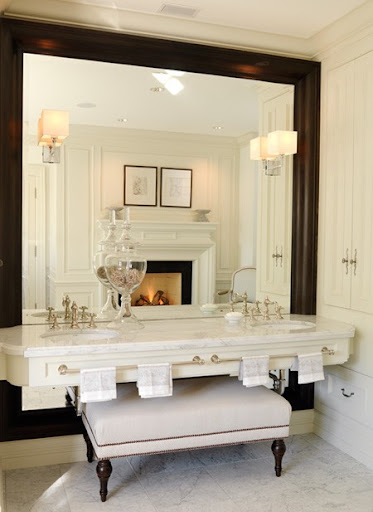 The oversized framed mirror and tucked ottoman add great interested to this bathroom -- the fire place doesn't hurt either. (houseandhome.com) The oversized framed mirror and tucked ottoman add great interested to this bathroom -- the fire place doesn't hurt either. (houseandhome.com)