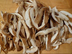 While the rice absorbs the broth, slice the mushroom caps