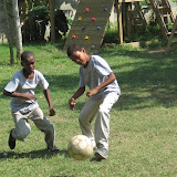Miguel Angel and Carlos Alfredo both aiming to kick the ball.