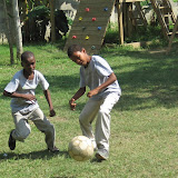 Miguel Angel and Carlos Alfredo both aiming to kick the ball.