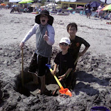 Matthew, Eidan, and Kai digging at the beach