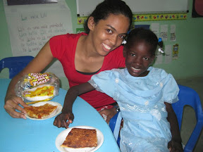 Profe Nicole and Miguelina love their pizza.