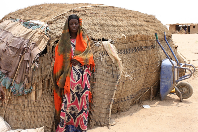 Maria Farah outside her ari, which her family of six shares with their calf and goat in Ethiopia, July 2011. 'It is boiled wheat for breakfast and for the main meal &ndash; we don't have anything else &ndash; no milk, no meat, no vegetables, no oil,' she says. Maria is one of thousands of new refugees in the Somali region after rains failed for the past two seasons. &copy; Jaspreet Kindra / IRIN