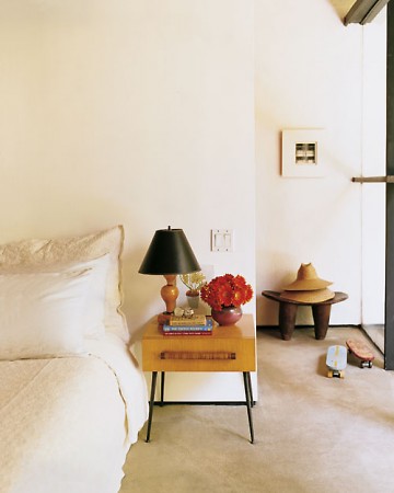 The white-and-grey color palette of this room is like a canvas—the owner's belongings are like little pops of color.