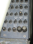 I saw this control panel to one side of the pilot. I find a few of these buttons quite interesting: cigar ltr, stereo, and flush toilet?