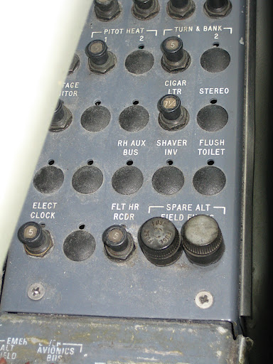 I saw this control panel to one side of the pilot. I find a few of these buttons quite interesting: cigar ltr, stereo, and flush toilet?