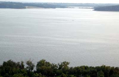 A lone boat cruises high waters on Lake Red Rock