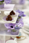 Different sized purple dyed doilies are used on the cake stands as well as under the truffles. Different sized purple dyed doilies are used on the cake stands as well as under the truffles.