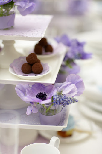 Different sized purple dyed doilies are used on the cake stands as well as under the truffles. Different sized purple dyed doilies are used on the cake stands as well as under the truffles.