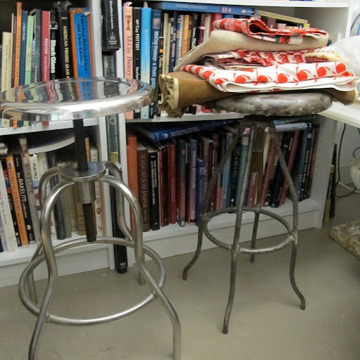 Vintage stools with a small footprint provide extra seating and serve as a good place to rest fabric samples, when not in use.