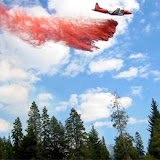One of the USFS's famous slurry bombers drops retardant on a forest fire.