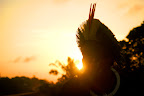 An indigenous warrior paints his face at sunrise before the occupation