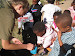 An All Out volunteer getting OVCs to wash their hands prior to eating.