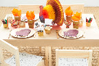 For the kids' table, I used brown craft paper as a tablecloth. Kids can decorate the paper with supplies such as crayons, stickers, or rubber stamps. I used flameless candles (the battery-pack ones) wrapped with the extra strips of gold-punched paper to create a For the kids' table, I used brown craft paper as a tablecloth. Kids can decorate the paper with supplies such as crayons, stickers, or rubber stamps. I used flameless candles (the battery-pack ones) wrapped with the extra strips of gold-punched paper to create a