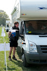 Andy the campsite manager instructs a French camper where to park