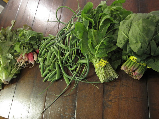 All kinds of leafy greens, including lettuce, spinach, arugula, and totsoi. Also radishes, peas and garlic scapes.