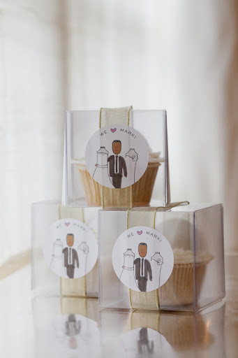 Guests took home a delicious cupcake from One Girl Cookies after the party. The boxes were wrapped in Raffit gold ribbon  and sealed with a custom Mark sticker from Avery Labels.