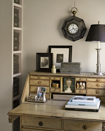An antique Swedish desk occupies a front corner of the bedroom; its many drawers keep mail out of sight. The desktop displays some of Eric's favorite possessions.