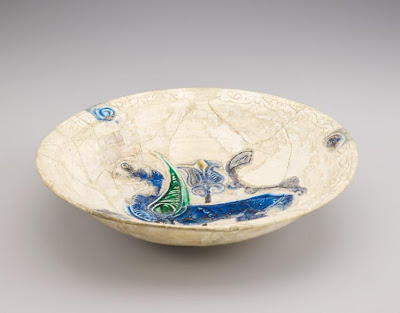 Deep bowl with winged griffon | Origin:  Iran | Period: 11th-12th century  Saljuq period | Details:  Not Available | Type: Stone-paste with carved decoration and colors in a transparent glaze | Size: H: 8.3  W: 34.4  cm | Museum Code: F1947.18 | Photograph and description taken from Freer and the Sackler (Smithsonian) Museums.