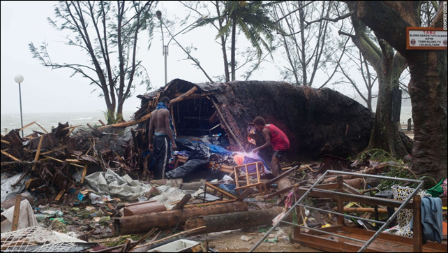 This handout photo taken and received on 14 March 2015 by UNICEF Pacific shows residents looking through storm damage caused by Cyclone Pam, in the Vanuatu capital of Port Vila. Photo: UNICEF Pacific
