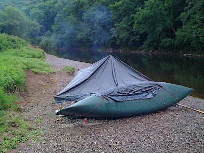 The Shelter rigged to the canoe, propped with a paddle, simple and effective: only needed a single peg into the bank to stay up as the canoe provides the support.