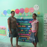 Yosmery and Narolin next to the first day of school message for the PK3 class.