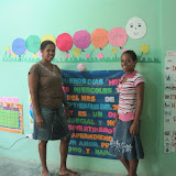 Yosmery and Narolin next to the first day of school message for the PK3 class.