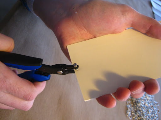 He began by punching a 1.25 mm round hole in each side of the chip.