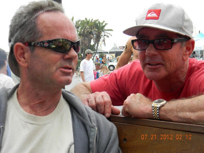 Bruce Logan (left) talking to his brother Brad at an event in Hermosa Bch. in 2012, looks like they are plotting something