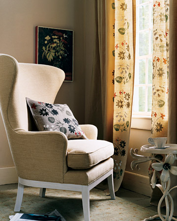 Two handmade floral stencils, arranged agreeably askew, decorate the inner edges of curtains, framing the window. Two handmade floral stencils, arranged agreeably askew, decorate the inner edges of curtains, framing the window.
