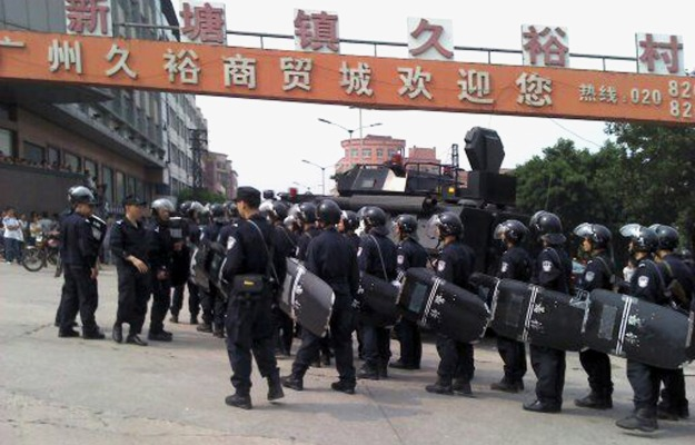 China police prepare for large demonstrations in the southern city of Guangzhou over rumors that police beat a street hawker to death and manhandled his pregnant wife, June 2011. oilandglory.foreignpolicy.com