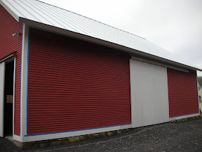 Since we finished this project the family has begun to paint their barn.  One coat down....