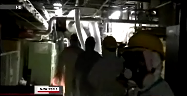 Workers enter the crippled Fukushima Daiichi nuclear plant. The health ministry says that another 23 workers at the nuclear plant may have been exposed internally to over 100 millisieverts of radiation. NHK