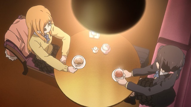 Kiriyama and Iori seen from above sitting across from each other at a cafe drinking tea bathed in orange light