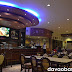 Inside Coco's South Bistro, with tables for families and a huge LCD TV