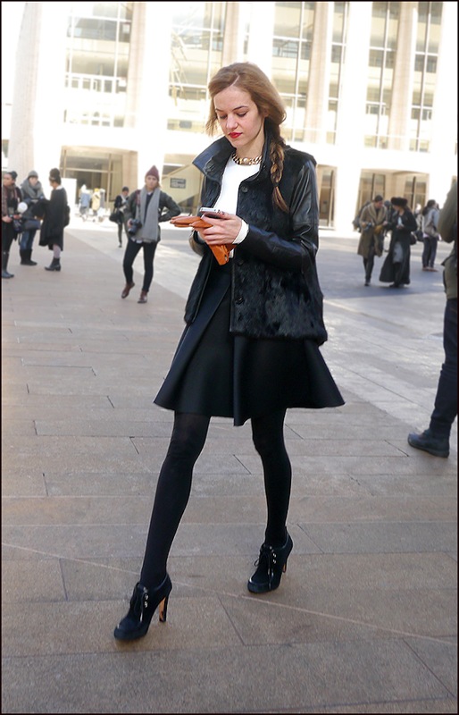 w black fur coat with leather sleeves white top short black skirt black stockings black  heels ol