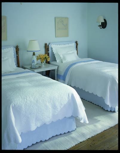 We updated these twin bed frames by covering the headboards in a soft color that matches the bedding.