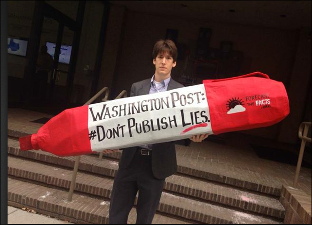 Brad Johnson holds a sign that reads, 'Washington Post: Don't publish lies'. On 20 February 2014, Brad Johnson (@climatebrad on Twitter) posted:'Today, 110,000 citizens told @washingtonpost to stop publishing climate lies like today's @krauthammer oped'. Photo: Brad Johnson / Twitter