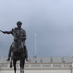 Storm clouds are brewing. A man on a horse doesn't look impressed.