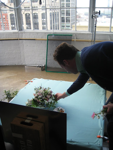 Matthew Robbins, on set, tweaking the bouquet for the shot.