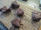 Cake shapes covered in chocolate and drying for 5 minutes.