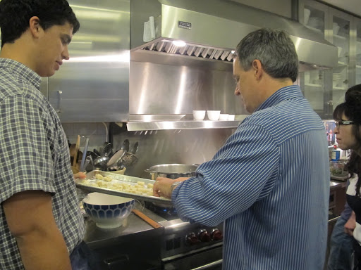 Paul adds the gnocchi to the pot