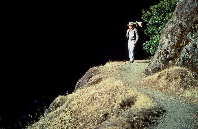 America The Beautiful - A hiker in the Wild & Scenic Area along southern Oregon's Rogue River near Paradise Lodge. This photograph was taken just above Blossom Bar and Devil's Staircase, for boaters and rafters two of the toughest stretches along the entire course of this river. Paradise is a fine lodge, but it is best reached by powerboats that traverse the river from Gold Beach. The Rogue is a fine salmon and steelhead fishery. Be sure to bring your camera. The scenery is breathtaking, especially in the spring and fall.
