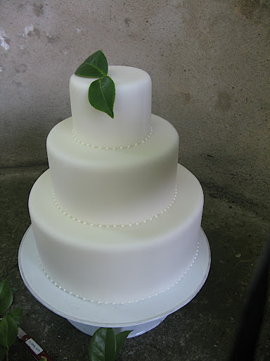 We propped it up on a cake stand, and then added flowers and foliage for a bit of color.