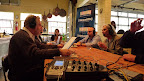 Jonathan speaking with his guests from his kitchen table.