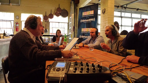 Jonathan speaking with his guests from his kitchen table.