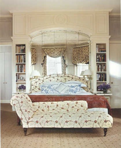 The bed in this European-traditional room is nestled in an alcove.