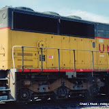 Back end of Union Pacific 6095 (SD60M) waiting for a crew change at the Main Street crossing in Fremont, Nebraska. (August 1999)