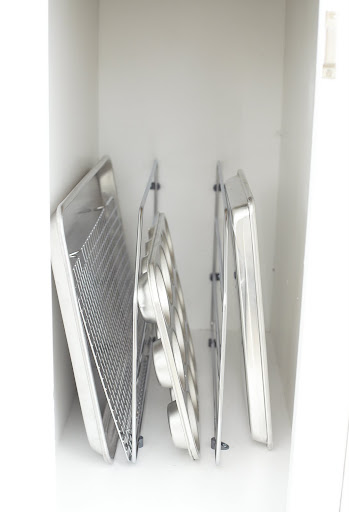 I use easily installed metal dividers to keep flat items organized vertically.