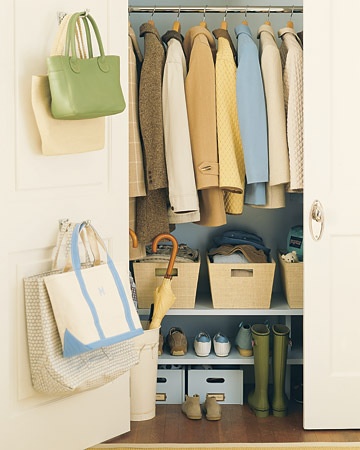 Another options is to install shelves below your coats. Here, each member of the family has their own bins for hats, gloves, and scarves.